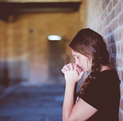 Girl Praying about Socially Responsible Catholic Investments